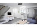 Open living room layout with modern lighting, gray flooring, and an inviting atmosphere at 800 Pritchard Avenue Ext # H4, Chapel Hill, NC 27516