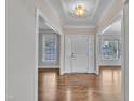 Spacious front entrance with hardwood flooring, stylish lighting, and access to multiple rooms at 805 Alden Bridge Dr, Cary, NC 27519