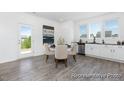 Bright dining area with modern table, neutral chairs, and sliding glass door at 94 Mable Court # 16, Lillington, NC 27546