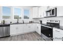 Bright kitchen with stainless steel appliances, granite countertops, and white cabinets at 94 Mable Court # 16, Lillington, NC 27546
