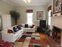 Cozy living room with fireplace, hardwood floors and ample natural light at 100 Lager Ln, Garner, NC 27529
