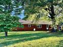 Backyard with mature trees and lawn at 1005 Driftwood Dr, Siler City, NC 27344