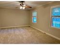 Spacious carpeted bedroom with ceiling fan and natural light at 1005 Driftwood Dr, Siler City, NC 27344