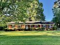 Brick home with a well-manicured lawn and mature trees at 1005 Driftwood Dr, Siler City, NC 27344