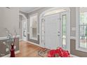 Inviting foyer with hardwood floors, a decorative front door, and elegant trim at 1016 Luminary Ln, Willow Springs, NC 27592