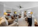 Cozy living room featuring a stone fireplace, plush seating, and a ceiling fan at 10520 Sablewood Dr # 103, Raleigh, NC 27617