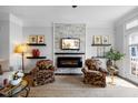 Inviting living room features a fireplace, decor shelving and sunlit windows at 10520 Sablewood Dr # 103, Raleigh, NC 27617