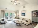 Living room with vaulted ceiling, modern decor, and access to the outdoor deck at 107 Long Shadow Ln, Cary, NC 27518