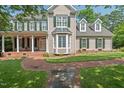 Charming home with manicured lawn, brick walkway, covered porch, and green shutters at 108 Hotelling Ct, Chapel Hill, NC 27514