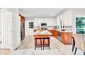 Modern kitchen features white cabinets, a center island with seating, and stainless steel appliances at 110 Glenrose Ln, Cary, NC 27518