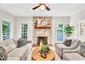 Cozy living room features a stone fireplace, hardwood floors, and lots of natural light at 110 Glenrose Ln, Cary, NC 27518