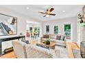 Bright living room boasts hardwood floors, neutral decor, and a view to the dining area at 110 Glenrose Ln, Cary, NC 27518