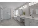 Luxurious bathroom with a glass-enclosed shower, soaking tub, and double vanity with modern fixtures at 110 Huntersville Rd, Morrisville, NC 27560