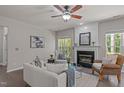 Inviting living room with a fireplace, neutral tones, bright windows and comfortable seating, perfect for relaxation at 110 Huntersville Rd, Morrisville, NC 27560