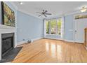 Light-filled living room featuring hardwood floors, a fireplace, and large windows at 111 Finsbury Street St, Durham, NC 27703