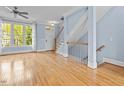 Bright living area with hardwood floors, a staircase, and large windows providing natural light at 111 Finsbury Street St, Durham, NC 27703
