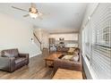 Inviting living room flowing into the kitchen featuring hardwood floors and natural light at 111 Laporte Path, Garner, NC 27529