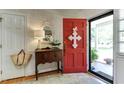 Inviting foyer with a striking red door, elegant decor, and warm, welcoming ambiance at 1206 Ivy Ln, Raleigh, NC 27609