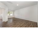 Empty living room with hardwood floors, and a large window providing abundant natural light at 1230 Adrian Ct, Mebane, NC 27302