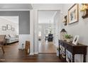 Inviting foyer featuring hardwood floors, console table, and views into the living and dining areas at 12417 Kendall Ridge Ct, Durham, NC 27703