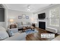 Bright living room with a cozy fireplace, modern decor, and ample seating for relaxation and entertainment at 12417 Kendall Ridge Ct, Durham, NC 27703
