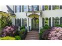 Close up of front entrance featuring double doors, brick steps, and manicured landscaping at 1329 Wynncrest Ct, Raleigh, NC 27603