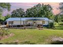 Quaint home featuring a covered front porch, blue accents and lush lawn at 155 G Herring Rd, Princeton, NC 27569