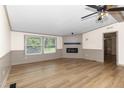Bright living room with fireplace, neutral tones, and wood-look flooring at 165 Dawn Rd, Benson, NC 27504