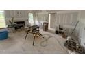 Open-concept living room with fireplace and large windows, under construction with drywall installed at 168 Clayton Rd, Princeton, NC 27569