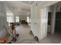 Open-concept living room with fireplace and large windows, under construction with drywall installed at 168 Clayton Rd, Princeton, NC 27569