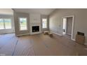 Bright living room featuring a fireplace, large windows, and neutral paint at 168 Clayton Rd, Princeton, NC 27569