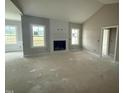 Bright living room features a cozy fireplace, vaulted ceiling, and large windows providing natural light at 168 Clayton Rd, Princeton, NC 27569