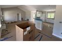 Open-concept living space with a fireplace, natural light, and modern kitchen area at 168 Clayton Rd, Princeton, NC 27569
