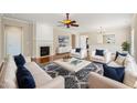 An open living room boasts hardwood flooring, a fireplace, neutral decor, and modern furnishings at 204 Dowington Ln, Cary, NC 27519