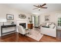 Cozy living room featuring a fireplace, ceiling fan, and comfortable seating arrangement at 209 Woodstar Dr, Cary, NC 27513