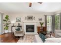 Cozy living room featuring a fireplace, ceiling fan, and comfortable seating arrangement at 209 Woodstar Dr, Cary, NC 27513