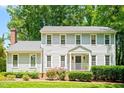 Charming two-story house features flowering bushes, healthy shrubs, and a cozy covered entrance at 2107 Somers Ave, Burlington, NC 27215