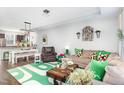 Inviting living room featuring modern furnishings, a green accent rug, and lots of natural light at 217 Jones Hill Rd, Holly Springs, NC 27540