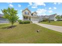 Beautiful two-story home with a well-maintained lawn and a concrete driveway at 225 Alcock Ln, Youngsville, NC 27596