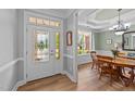 Welcoming foyer with stained glass door and sidelights, leading to a dining room with natural light and wood floors at 232 Shady Hollow Ln, Garner, NC 27529