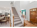 Bright and spacious foyer with hardwood floors, a staircase, and views into the living spaces at 2408 Fordcrest Dr, Apex, NC 27502