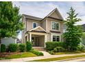 Well-maintained two-story home with a cozy front porch and lush greenery at 249 Salt Cedar Ln, Chapel Hill, NC 27516