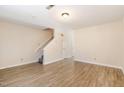 Spacious living room with natural light, staircase, and wood-look flooring at 2519 Hitchcock Dr, Durham, NC 27705