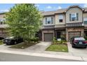 Beautiful townhome exterior with manicured landscaping, stone accents, and attached garages at 256 Rubrum Dr, Hillsborough, NC 27278