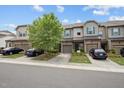View of the townhomes and street, showcasing the home's curb appeal and landscaping at 256 Rubrum Dr, Hillsborough, NC 27278