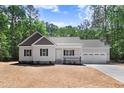 Charming single-Gathering home featuring an attached two-car garage and manicured lawn at 295 Rudd Rd, Youngsville, NC 27596