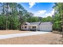 Charming single-Gathering home featuring an attached two-car garage, front porch, and long driveway at 295 Rudd Rd, Youngsville, NC 27596