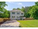 Lovely two-story home with a well-maintained lawn, complemented by mature trees and a quaint shed at 3003 University Dr, Durham, NC 27707