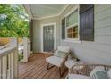 Charming porch featuring comfortable chairs, a side table, and a welcoming ambiance at 3003 University Dr, Durham, NC 27707