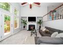 Spacious living room with high ceilings, fireplace, large windows, and natural light at 3034 Winfred Dell Ln, Cary, NC 27511